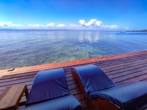 博卡斯德尔托罗Bahia Coral Lodge的木甲板上一对蓝色椅子