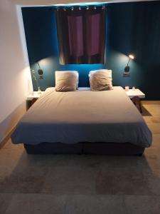 拉西约塔Chalet détente proche plage的一间卧室配有一张带蓝色墙壁的大床