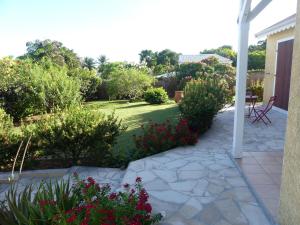 拜马欧Villa Magnifique piscine & jardin的庭院设有种有鲜花和植物的花园
