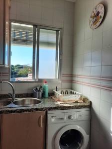 埃尔波提尔Mi bonito apartamento del Portil的厨房配有洗衣机和水槽