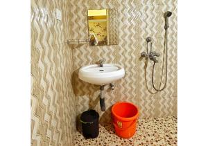 安君纳THE MUSAFIR HOSTEL的一间带水槽和水桶的浴室