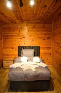 萨潘贾Vg Bungalow Sapanca的卧室配有木墙内的一张床
