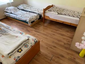 布达佩斯红色机车公寓 的铺有木地板的客房内的两张床