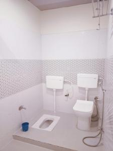 加雅The Royal Sahdeo Venue的白色的浴室设有卫生间和水槽。