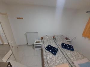 皮罗特Guest House Vila Banjica的白色的小房间,配有蓝色枕头的床