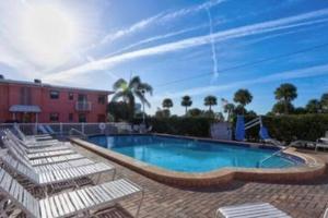 圣徒皮特海滩Ocean view balcony with heated pool的一座带躺椅的游泳池位于大楼旁