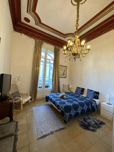 巴塞罗那Barcelona Central Apartments的一间卧室配有蓝色的床和吊灯。