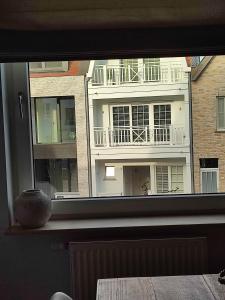 克诺克－海斯特Le Knok'Koon Un cocon à Knokke avec garage et emplacement gratuits的享有大楼景致的窗户