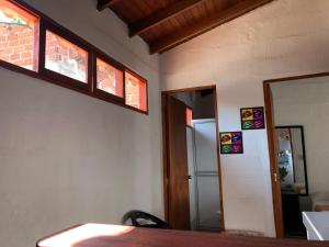 圣菲德安蒂奥基亚apartasuite Centro Historico的一间设有桌子、两个窗户和一扇门的房间