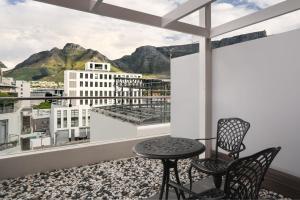 开普敦Protea Hotel Fire & Ice by Marriott Cape Town的设有一个配有桌椅并享有美景的阳台。