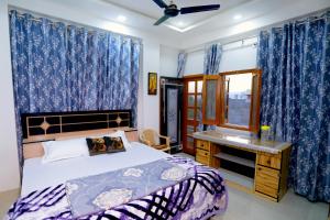 乌代浦Bhagora CJMA Home Stay/Villa的一间卧室配有一张床、一张书桌和一个窗户。