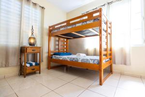 伊莎贝拉Colinas Del Atlantico 2 floors的一间卧室设有两张双层床和床头柜。