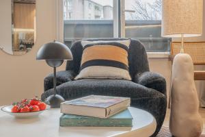 巴黎Yuna Porte-Maillot - ApartHotel的客厅配有椅子和桌子及书籍