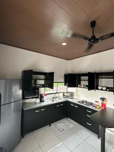 奎波斯城Apartamento Rodriguez的一间设有黑色橱柜和天花板的大厨房