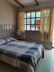 塔拉波托Residencial Carloz的一间卧室设有一张大床和一个窗户。