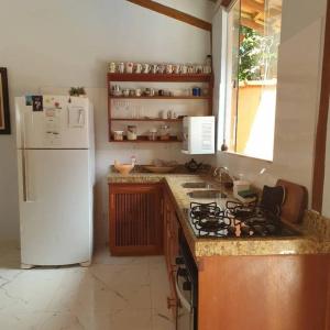 塞古罗港Tiny house的厨房配有白色冰箱和炉灶。