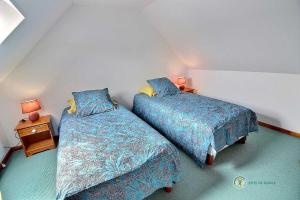 普卢巴拉内克Ar vag的一间卧室设有两张床和床头柜
