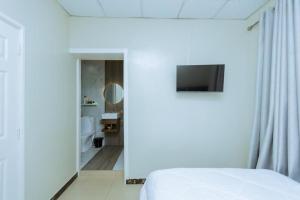 基加利Ibi Villa Retreat的一间带白色床的卧室和一间浴室