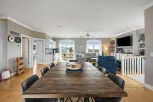 霍尔顿海滩Bird's Nest的用餐室以及带木桌和椅子的客厅。