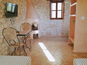索维拉Riad Mamy Wababi的客房设有桌椅和壁炉。