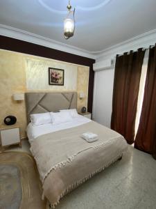 Dar el BeïdaHostel Apart的卧室配有带白色枕头的大床