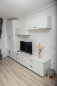 巴亚马雷Maria's Premium Suite的一间白色的客厅,客厅内配有梳妆台上的电视