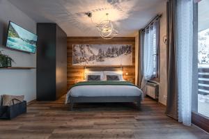 帕苏德尔托纳莱Diamante ampio monolocale stile chalet alpino的一间卧室配有一张床和一个吊灯