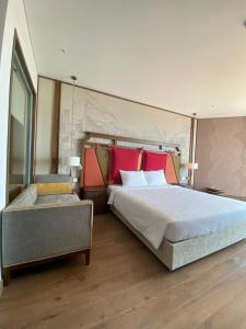 Ấp Thiẹn ÁiLuxury APEC MANDALA MŨI NÉ SG HAPPY HOUSE的一间卧室配有一张带红色枕头的大床