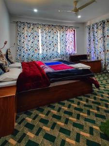 帕哈尔加姆Tip Top Pahalgam的卧室内的一张大床,带窗帘