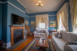 斯坦利Poet's Cottage Stanley的客厅设有蓝色的墙壁和壁炉。