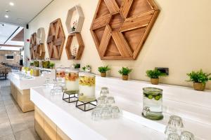 拉加纳斯White Olive Elite Laganas的展示玻璃和花瓶的酒吧