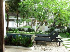 普卢坎Deepblue vila的一个带长凳和游泳池的花园