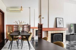 雅典Capacious 3BR apartment in the heart of Marousi的一间带桌椅和壁炉的用餐室