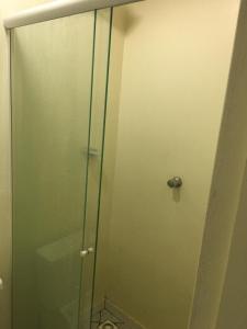 沙佩科Loft confortável no Centro的浴室里设有玻璃门淋浴