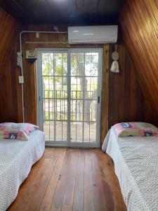 康考迪亚La alpina playa nebel的客房设有两张床和大窗户。
