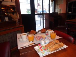 巴黎德格尔巴黎圣母院酒店的一张桌子,上面放着一盘食物和橙汁