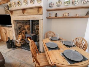 赫克瑟姆Swinhope View的一间带木桌和壁炉的用餐室