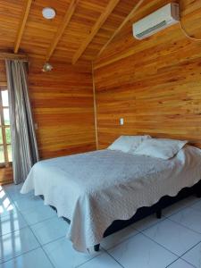 埃尔索韦维奥Cabañas El Mirador的一间卧室配有一张木墙床