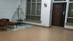 乌鲁地南Zulaikha's Homestay Ulu Tiram Johor Bahru的隔壁的房间配有桌子和椅子
