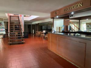 米娜克拉韦罗Hotel Rossetti y Spa的一间带酒吧的餐厅以及一个带桌子的厨房