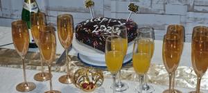 安博塞利Little Amanya Camp的一张桌子,上面放有香槟酒杯和生日蛋糕