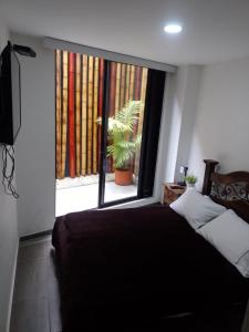 亚美尼亚APTO EN NORTE DE ARMENIA的一间卧室配有一张床和一个植物窗户