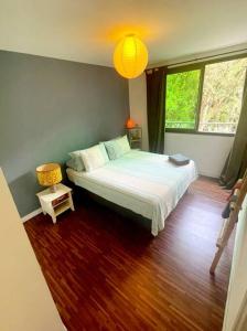 普纳奥亚E KOMO MAI的一间卧室设有一张大床,铺有木地板
