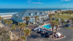 圣奥古斯丁Ocean Sands Beach Boutique Inn-1 Acre Private Beach-St Augustine Historic-2 Miles-Shuttle with Downtown Tour-HEATED Salt Water Pool until 4AM-Popcorn-Cookies-New 4k USD Black Beds-35 Item Breakfast-Eggs-Bacon-Starbucks-Free Guest Laundry-Ph#904-799-SAND的享有酒店空中景色,设有停车场和海滩