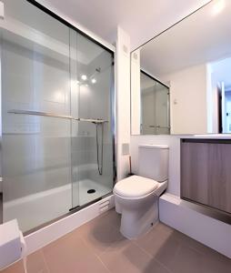 拉塞雷纳Condominio Pacífico 3100的白色的浴室设有卫生间和淋浴。