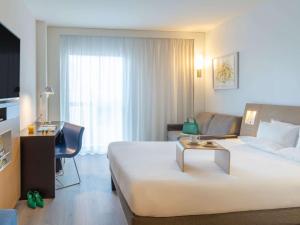 巴塞罗那诺富特巴塞罗那城市酒店的酒店客房设有一张大床和一张书桌。