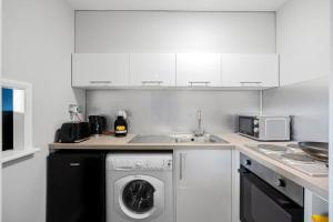 KentStudio Apartment in Central Maidstone的厨房配有洗衣机和水槽