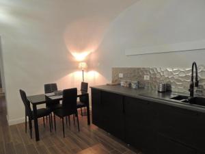 罗马Le Piccole Lune di Monti的一间带桌椅的厨房和一间带灯的厨房