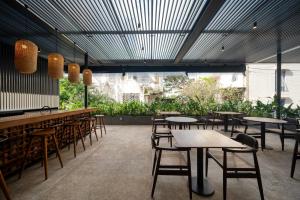 科伦坡Taprobane House的一间设有桌椅的餐厅,种植了植物