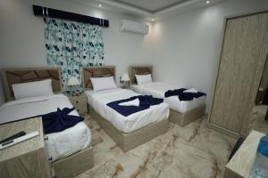 开罗Capital Of Pyramids Hotel的一间卧室配有两张蓝色床单